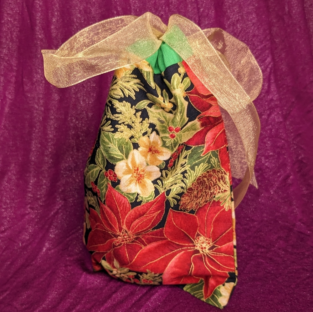Reusable fabric Christmas giftbag with poinsettias and gold ribbon